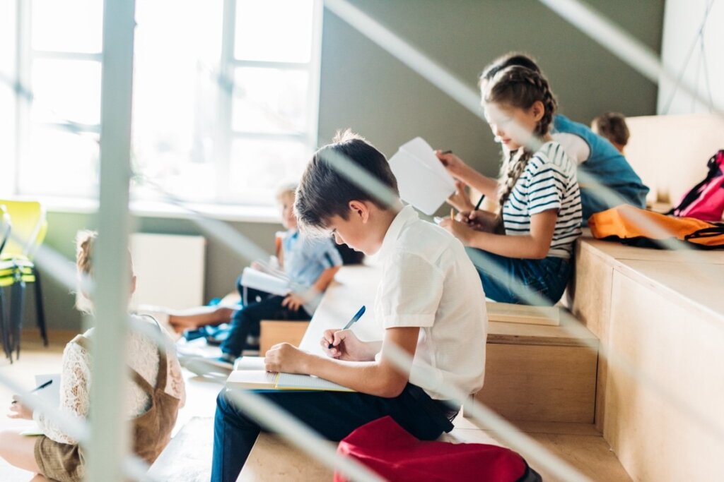 children engage in a writing assignment in a classroom