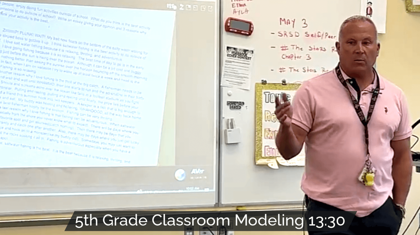 5th-grade teacher modeling SRSD to students in a classroom, with a projected essay on the screen and the title 'SRSD Classroom Modeling in 5th Grade'