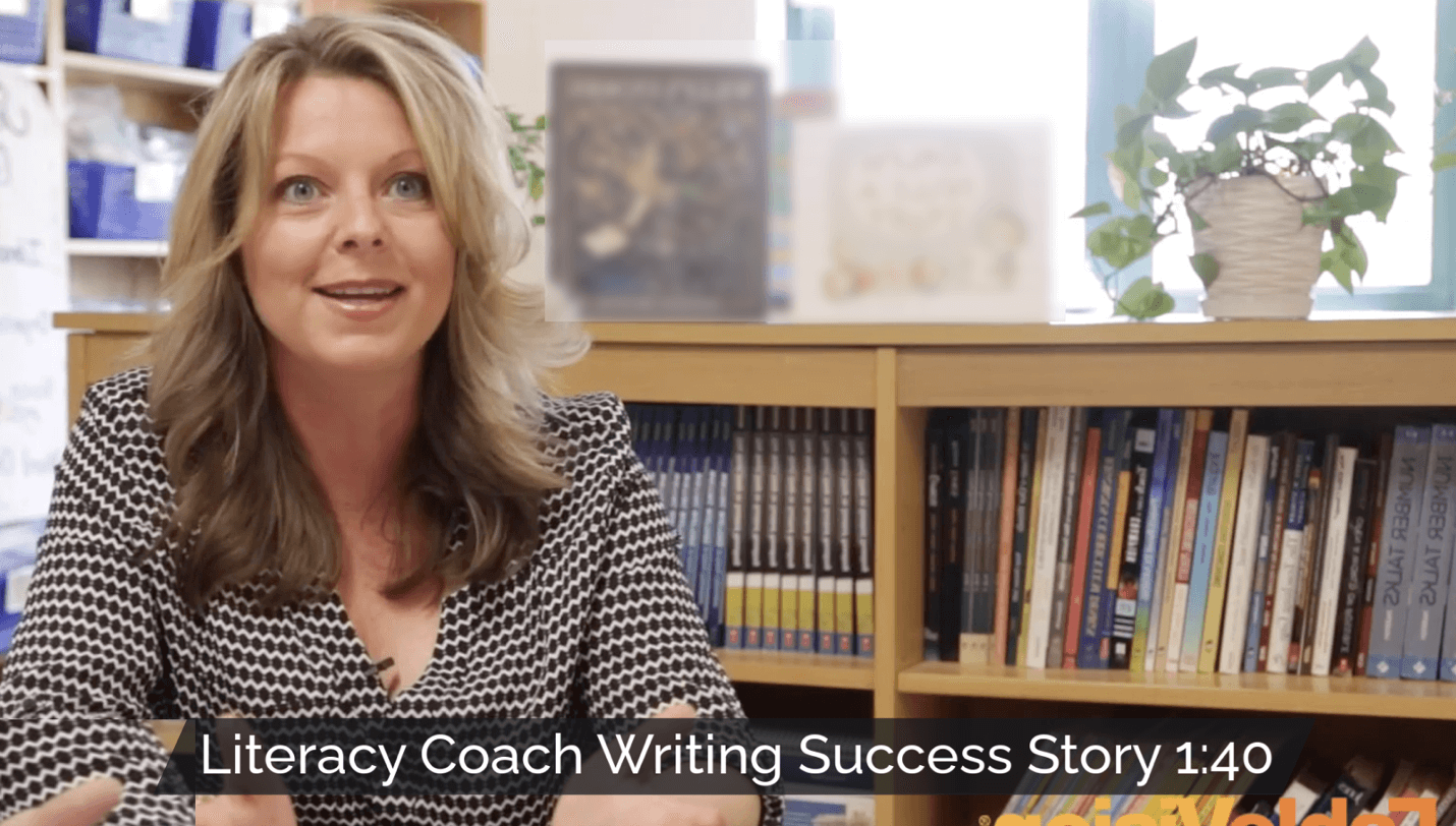 Literacy coach smiling in a classroom setting with the title 'Literacy Coach Writing Success Story' and video length indicator, 1:40, shown on the image.