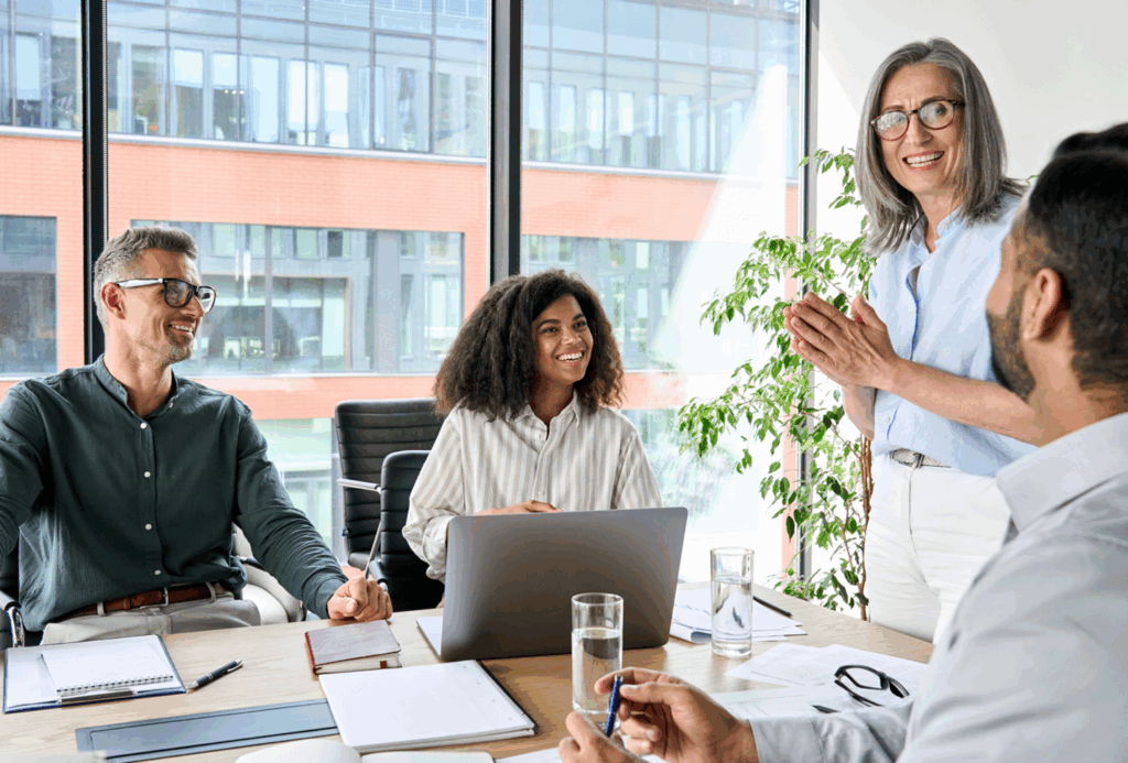 Diverse group of professionals having a positive discussion in a modern office meeting room.