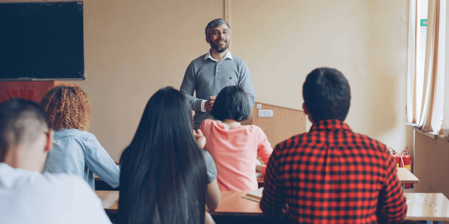 Teacher leading a lesson in front of a classroom of students